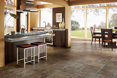 Inspiration for a mid-sized transitional ceramic tile and brown floor eat-in kitchen remodel in Orange County with an undermount sink, flat-panel cabinets, dark wood cabinets, soapstone countertops, stainless steel appliances and a peninsula