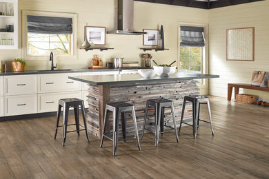 Photo of a large rural kitchen in Orange County with a submerged sink, beige splashback, wood splashback, stainless steel appliances, dark hardwood flooring, an island and brown floors.