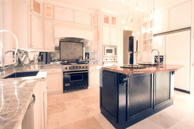 Example of a classic kitchen design in Sacramento with an undermount sink, raised-panel cabinets, black cabinets, granite countertops, mirror backsplash, paneled appliances, an island and multicolored countertops