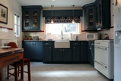 Eat-in kitchen - small 1950s l-shaped porcelain tile and white floor eat-in kitchen idea in Philadelphia with a farmhouse sink, glass-front cabinets, gray cabinets, granite countertops, white backsplash, ceramic backsplash and white appliances