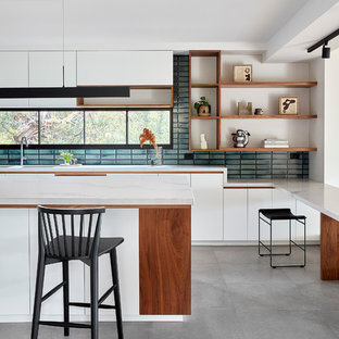 Design ideas for a large contemporary galley eat-in kitchen in Melbourne with open cabinets, white cabinets, quartz benchtops, mosaic tile splashback, porcelain floors, with island, grey floor, blue splashback, white benchtop, an integrated sink and stainless steel appliances.