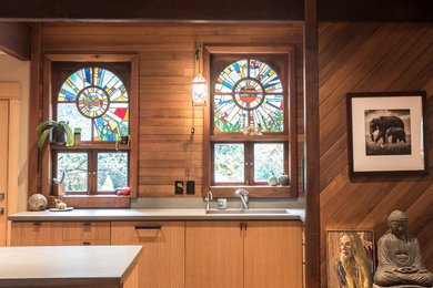 Example of a mid-sized eclectic light wood floor eat-in kitchen design in Portland with an undermount sink, flat-panel cabinets, medium tone wood cabinets, concrete countertops and gray backsplash