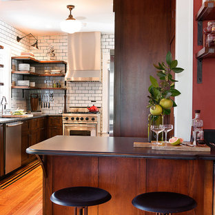 Inspiration for a craftsman u-shaped kitchen remodel in Jacksonville with shaker cabinets, dark wood cabinets, white backsplash, subway tile backsplash and stainless steel appliances