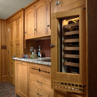 Craftsman enclosed kitchen ideas - Inspiration for a craftsman u-shaped slate floor enclosed kitchen remodel in Minneapolis with an undermount sink, shaker cabinets, medium tone wood cabinets, granite countertops, red backsplash, subway tile backsplash, paneled appliances and an island