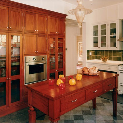 Tuscan gray floor kitchen photo in San Francisco with glass-front cabinets, medium tone wood cabinets, green backsplash and white appliances
