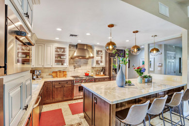Mid-sized elegant l-shaped eat-in kitchen photo in Phoenix with an undermount sink, raised-panel cabinets, beige cabinets, stainless steel appliances and an island