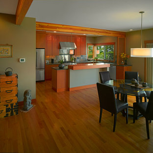 Inspiration for a mid-sized asian galley open plan kitchen in Seattle with flat-panel cabinets, medium wood cabinets, stone tile splashback, stainless steel appliances, marble floors, with island and a double-bowl sink.