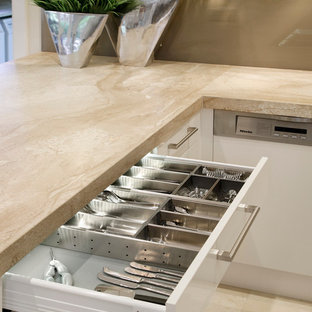 Photo of a mid-sized contemporary u-shaped open plan kitchen in Sydney with an undermount sink, flat-panel cabinets, white cabinets, marble benchtops, brown splashback, glass sheet splashback, stainless steel appliances and travertine floors.
