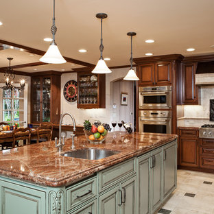 Large traditional l-shaped eat-in kitchen in San Francisco with raised-panel cabinets, beige splashback, an undermount sink, medium wood cabinets, granite benchtops, ceramic splashback, panelled appliances, ceramic floors and with island.