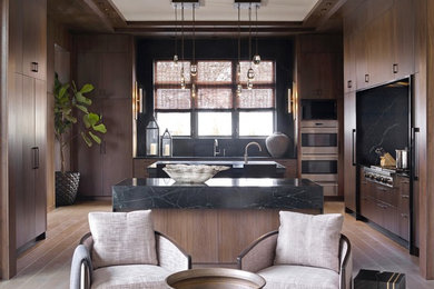Inspiration for a large transitional u-shaped light wood floor and gray floor open concept kitchen remodel in Atlanta with a double-bowl sink, flat-panel cabinets, dark wood cabinets, soapstone countertops, green backsplash, marble backsplash, paneled appliances, two islands and green countertops