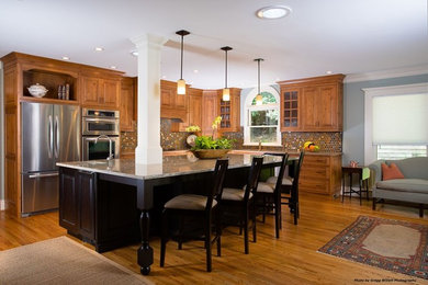 Eat-in kitchen - large traditional l-shaped light wood floor and brown floor eat-in kitchen idea in Atlanta with an undermount sink, light wood cabinets, granite countertops, multicolored backsplash, mosaic tile backsplash, stainless steel appliances, an island and beaded inset cabinets