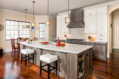 Inspiration for a mid-sized transitional l-shaped medium tone wood floor and brown floor eat-in kitchen remodel in Atlanta with shaker cabinets, white cabinets, two islands, a farmhouse sink, white backsplash, stainless steel appliances, subway tile backsplash and granite countertops