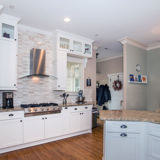 Eat-in kitchen - mid-sized craftsman u-shaped medium tone wood floor eat-in kitchen idea in Atlanta with a drop-in sink, shaker cabinets, white cabinets, granite countertops, beige backsplash, ceramic backsplash, stainless steel appliances and no island