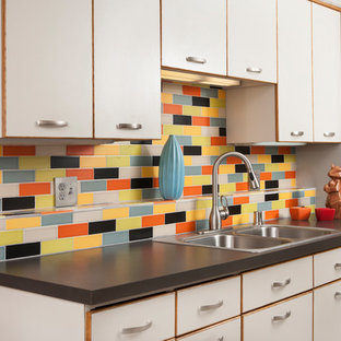 Inspiration for a mid-sized midcentury galley separate kitchen in Minneapolis with a drop-in sink, white cabinets, laminate benchtops, multi-coloured splashback, ceramic splashback, white appliances and no island.