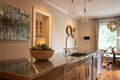 Example of a mid-sized transitional medium tone wood floor eat-in kitchen design in Atlanta with a drop-in sink, recessed-panel cabinets, stainless steel countertops, stainless steel appliances and an island