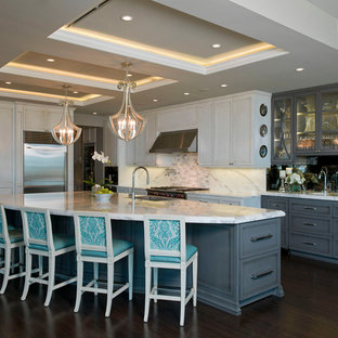 Contemporary kitchen appliance - Example of a trendy l-shaped kitchen design in Austin with recessed-panel cabinets, white cabinets, white backsplash and stainless steel appliances