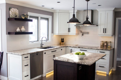 Inspiration for a large transitional porcelain tile and gray floor kitchen remodel in Toronto with an undermount sink, shaker cabinets, white cabinets, granite countertops, white backsplash, subway tile backsplash, stainless steel appliances and an island