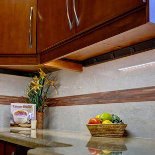 Transitional kitchen designs - Inspiration for a transitional kitchen remodel in Las Vegas with flat-panel cabinets, medium tone wood cabinets, granite countertops, beige backsplash, stone tile backsplash and stainless steel appliances