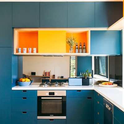 Kitchen - contemporary l-shaped medium tone wood floor kitchen idea in Sydney with flat-panel cabinets, blue cabinets and stainless steel appliances