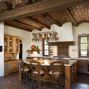 Mediterranean kitchen pictures - Inspiration for a mediterranean l-shaped kitchen remodel in Denver with distressed cabinets and stainless steel appliances