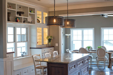 Eat-in kitchen - transitional galley eat-in kitchen idea in Birmingham with an undermount sink, flat-panel cabinets, brown cabinets, granite countertops, white backsplash, ceramic backsplash and paneled appliances