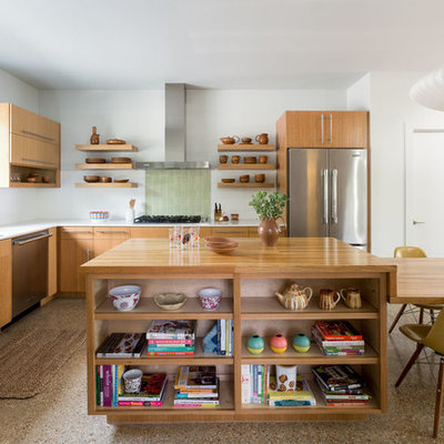 1960s l-shaped brown floor eat-in kitchen photo in Other with a double-bowl sink, flat-panel cabinets, medium tone wood cabinets, wood countertops, green backsplash, stainless steel appliances and an island