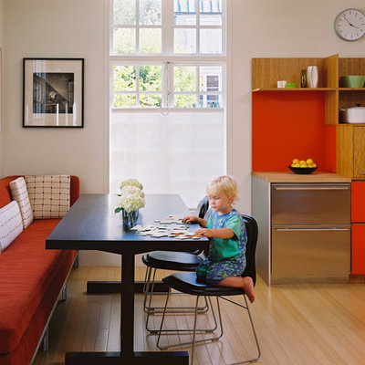 Inspiration for a mid-sized contemporary u-shaped light wood floor eat-in kitchen remodel in San Francisco with flat-panel cabinets, stainless steel appliances, an island, an undermount sink, green cabinets, wood countertops, multicolored backsplash and mosaic tile backsplash