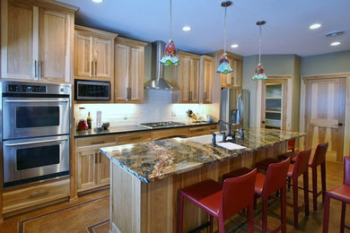 Inspiration for a mid-sized craftsman single-wall eat-in kitchen remodel in Minneapolis with flat-panel cabinets, light wood cabinets and an island