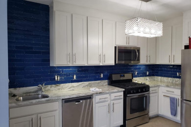 Example of a mid-sized trendy vinyl floor and gray floor kitchen design in Baltimore with blue backsplash and ceramic backsplash