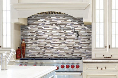 Inspiration for a timeless kitchen remodel in New York with an undermount sink, beaded inset cabinets, white cabinets, multicolored backsplash, matchstick tile backsplash and an island