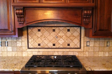 Inspiration for a large timeless l-shaped eat-in kitchen remodel in Atlanta with raised-panel cabinets, medium tone wood cabinets, granite countertops, multicolored backsplash, stone tile backsplash and stainless steel appliances
