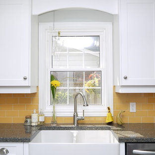 This is an example of a mid-sized country l-shaped separate kitchen in Toronto with a farmhouse sink, recessed-panel cabinets, white cabinets, quartz benchtops, yellow splashback, porcelain splashback, stainless steel appliances and with island.