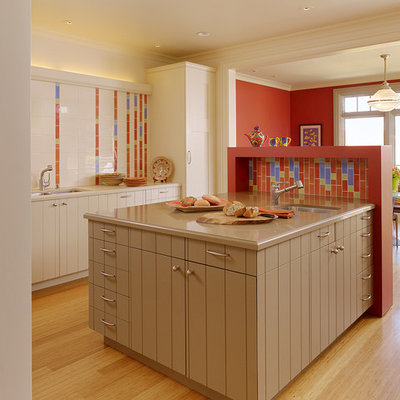 Example of a large eclectic l-shaped light wood floor eat-in kitchen design in San Francisco with a double-bowl sink, multicolored backsplash, beige cabinets, ceramic backsplash, stainless steel appliances and an island