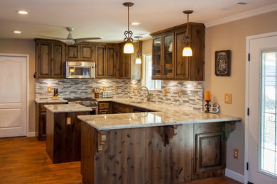 Eat-in kitchen - mid-sized traditional u-shaped dark wood floor and brown floor eat-in kitchen idea in Other with a double-bowl sink, raised-panel cabinets, dark wood cabinets, granite countertops, gray backsplash, matchstick tile backsplash, stainless steel appliances and an island