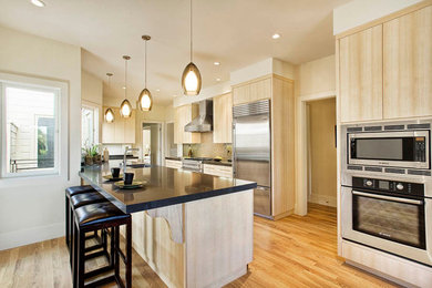 Mid-sized trendy u-shaped light wood floor and beige floor eat-in kitchen photo in San Francisco with an undermount sink, flat-panel cabinets, light wood cabinets, stainless steel appliances and a peninsula