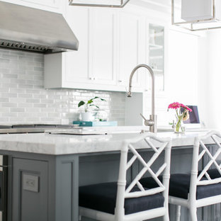 Large coastal open concept kitchen pictures - Open concept kitchen - large coastal l-shaped dark wood floor open concept kitchen idea in Orange County with a farmhouse sink, white cabinets, marble countertops, gray backsplash, ceramic backsplash, stainless steel appliances, an island and shaker cabinets