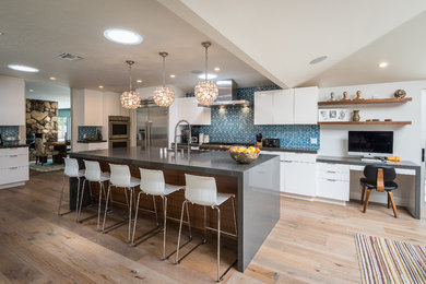 Inspiration for a large contemporary medium tone wood floor open concept kitchen remodel in Los Angeles with an undermount sink, flat-panel cabinets, white cabinets, quartz countertops, blue backsplash, ceramic backsplash, stainless steel appliances and an island