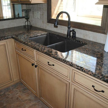 Baltic Brown Granite with Tile Backsplash. Maple Cabinets