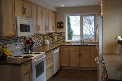 Example of a mid-sized transitional u-shaped linoleum floor enclosed kitchen design in Edmonton with a single-bowl sink, recessed-panel cabinets, light wood cabinets, laminate countertops, multicolored backsplash, matchstick tile backsplash and white appliances