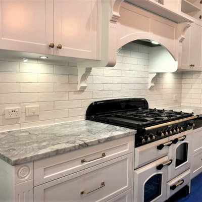 Kitchen pantry - mid-sized traditional kitchen pantry idea in Brisbane with a drop-in sink, shaker cabinets, white cabinets, granite countertops, white backsplash, subway tile backsplash, white appliances, an island and gray countertops