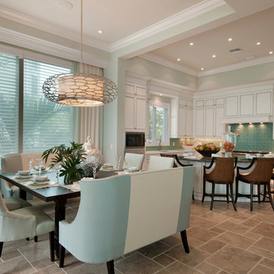 Example of a transitional beige floor eat-in kitchen design in Miami with white cabinets and paneled appliances