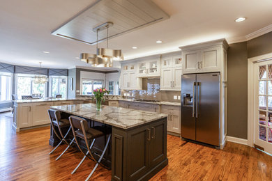 Eat-in kitchen - large transitional u-shaped eat-in kitchen idea in Other with flat-panel cabinets, white cabinets, quartzite countertops, beige backsplash, glass tile backsplash, an island and white countertops