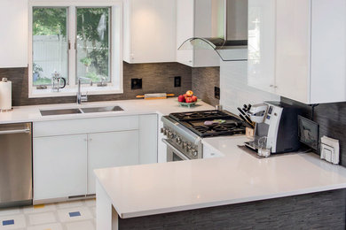 Example of a trendy u-shaped linoleum floor kitchen pantry design in Providence with an undermount sink, glass-front cabinets, white cabinets, quartz countertops, gray backsplash and stainless steel appliances