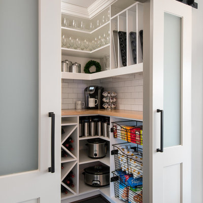 Example of a small transitional dark wood floor and brown floor kitchen pantry design in Detroit with white cabinets, white backsplash, subway tile backsplash, stainless steel appliances, a farmhouse sink, wood countertops, white countertops and open cabinets