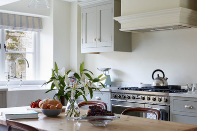 Classic kitchen/diner in Other with a double-bowl sink, shaker cabinets and quartz worktops.