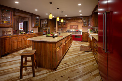 Inspiration for a rustic u-shaped light wood floor eat-in kitchen remodel in Other with a farmhouse sink, glass-front cabinets, dark wood cabinets, granite countertops, colored appliances and an island