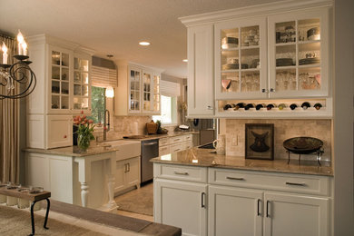 Example of a mid-sized classic galley travertine floor eat-in kitchen design in Minneapolis with a farmhouse sink, shaker cabinets, white cabinets, granite countertops, beige backsplash, stone tile backsplash, stainless steel appliances and a peninsula