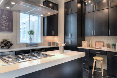 Inspiration for a mid-sized contemporary u-shaped dark wood floor eat-in kitchen remodel in Houston with an undermount sink, flat-panel cabinets, dark wood cabinets, quartz countertops, beige backsplash, mosaic tile backsplash, stainless steel appliances and an island