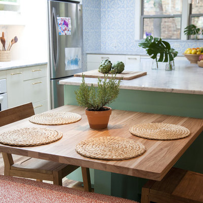 Inspiration for a mediterranean kitchen remodel in Austin with marble countertops and white appliances