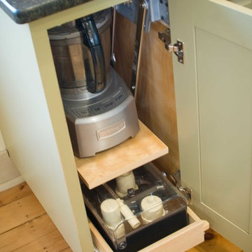 Base cabinet storage for food processor, adjacent to prep space and island.